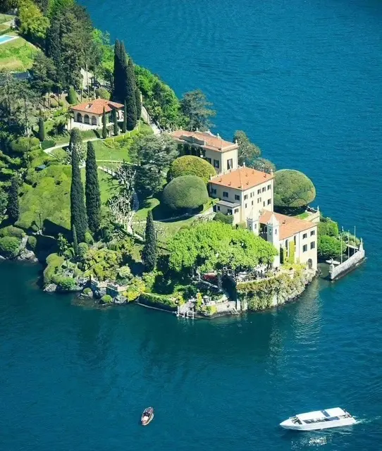 Lakeside villa with lush gardens