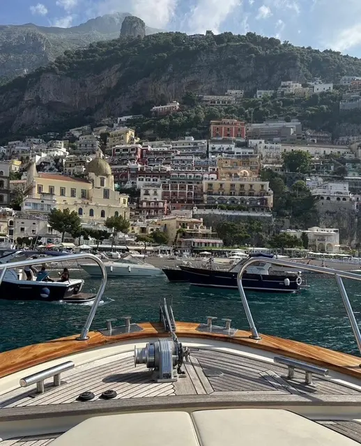 Boat approaching scenic coastal town
