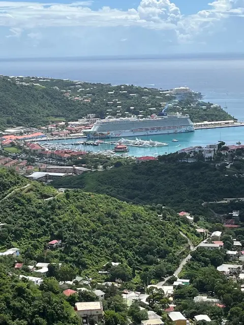 Lush green hills surrounding cruise port
